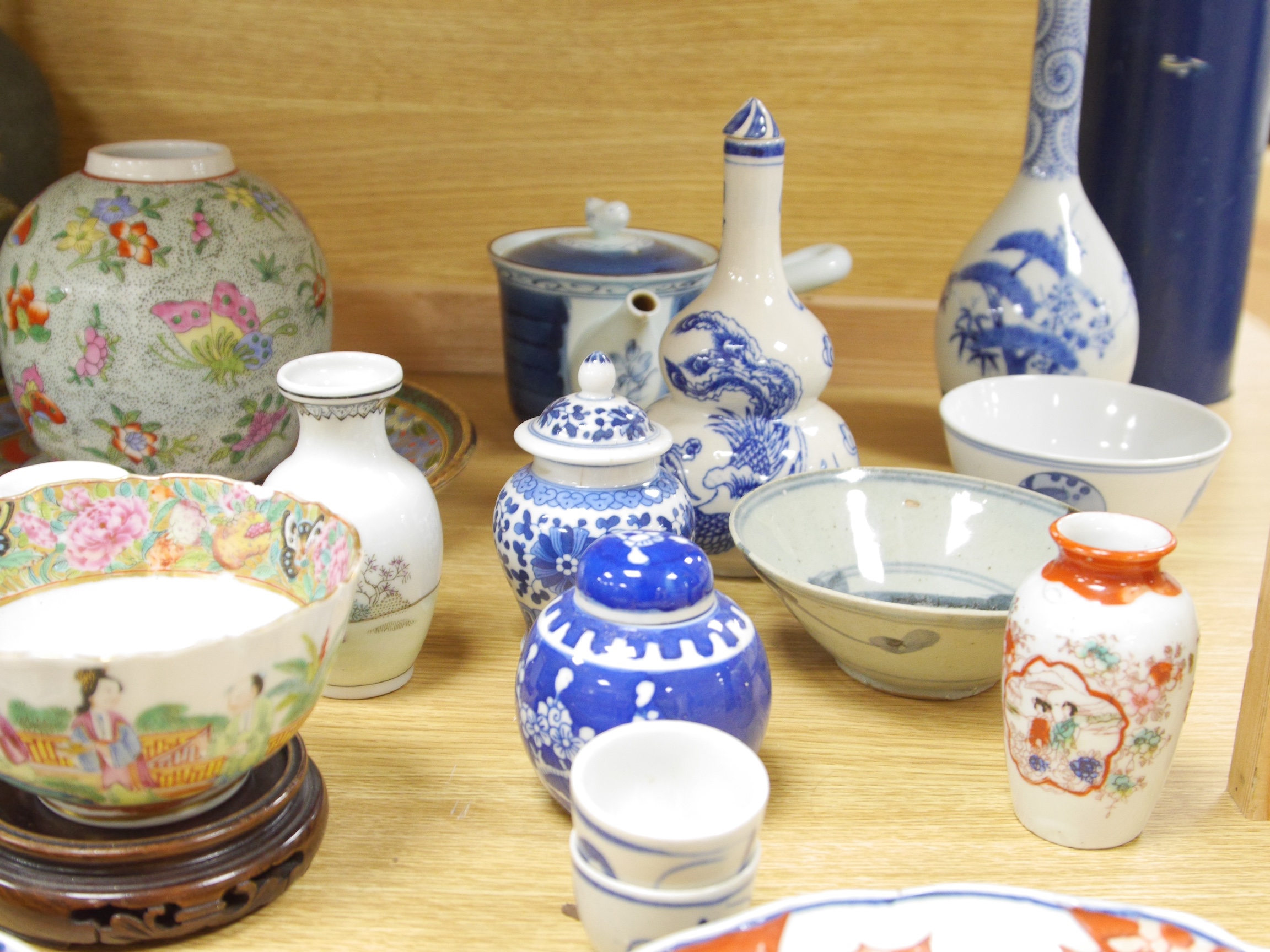 A large quantity of Chinese and Japanese ceramics and metalware to include Imari plates, blue and white vases and brass dishes, largest 37cm high. Condition - mostly fair to good